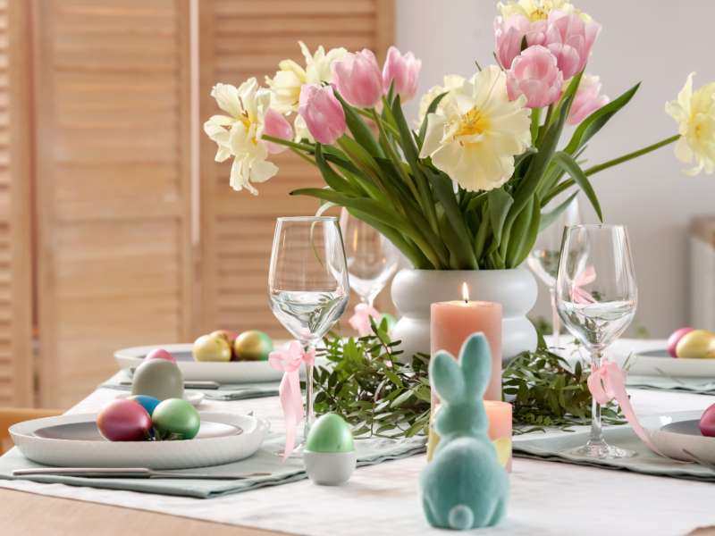 Chemin de table de Pâques avec fleurs fraîches, séchées et objets décoratifs